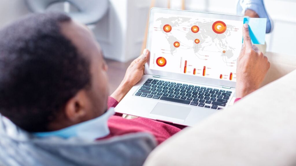 A man checking a statistics report on a laptop