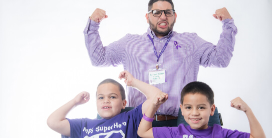 Family flexing muscles and smiling with tshirts for MPS awareness