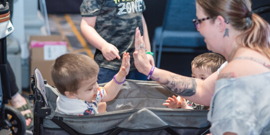 Baby and mother high-five for newborn screening for MPS