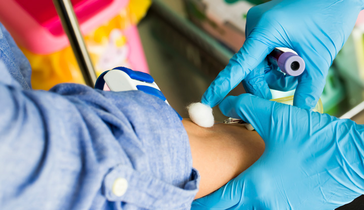 A provider takes a blood sample from a patient