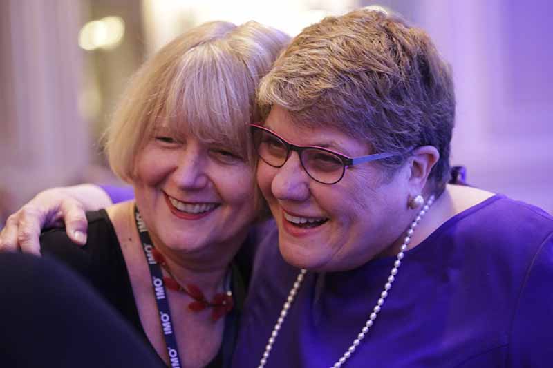 Close-up of two women smiling broadly