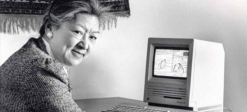 Nina Matheson at her desk, an old desktop computer next to her