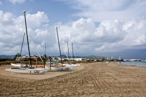 Cloudy day on a beach in Eivissa (Illes Balears, Spain), with boats in the sand.