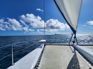 The Catamaran sailing thru gusty wind and high waves.
