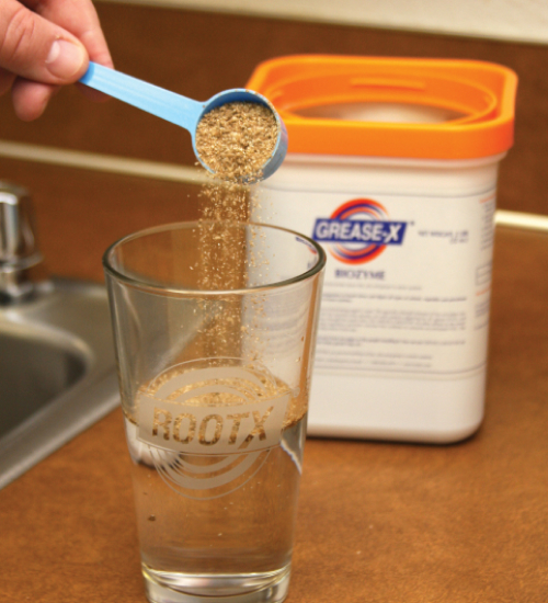 Grease-X product being poured into a glass with water