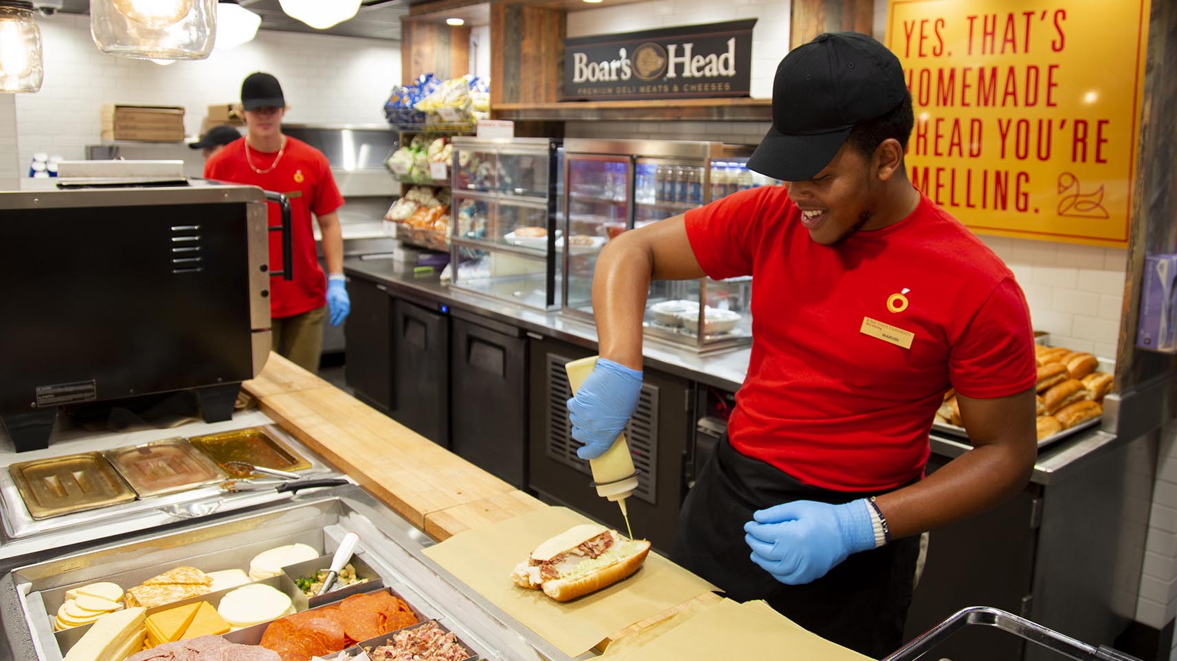 An ISU Dining student employee making a sandwich at the Lance and Ellies venue.