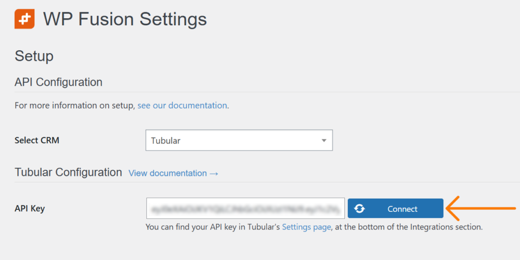 screenshot of the wp fusion settings page. dropdown menu shows tubular as the selected crm, highlighting the integration with wordpress. a blurred api key field sits next to a connect button with an orange arrow. links for documentation and settings are clearly visible.