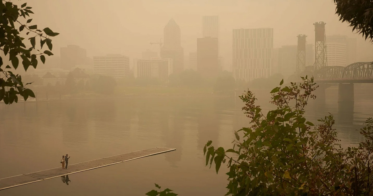 Orange smoke from wildfire over city