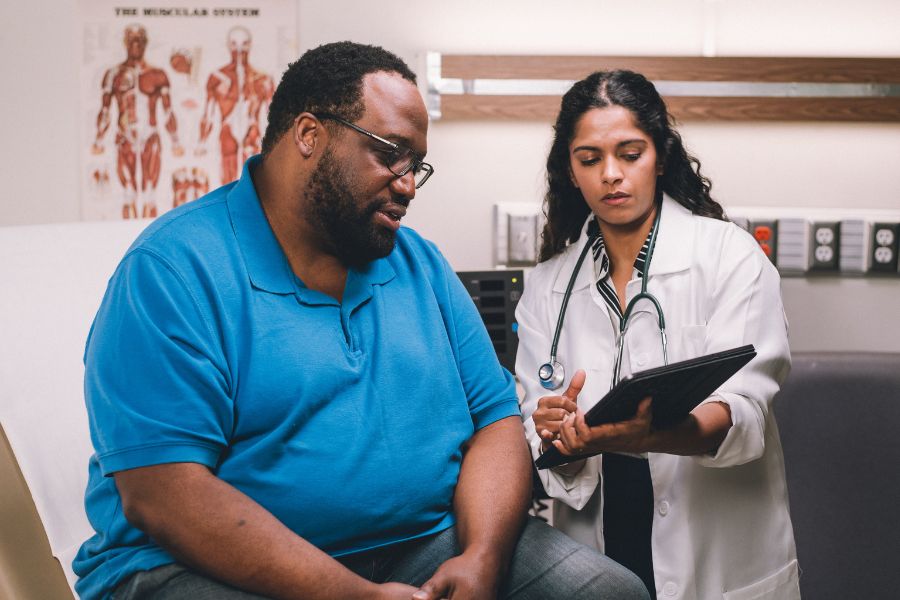 Image from OAC's Stop Weight Bias Image Gallery, featuring a male patient with obesity and a female doctor