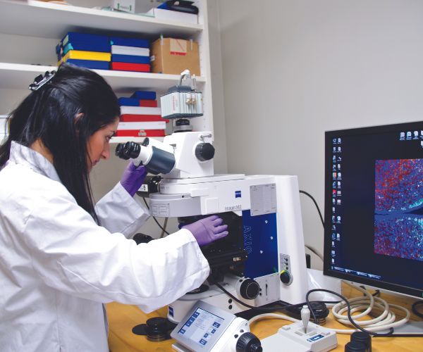 Student looking into a microscope.