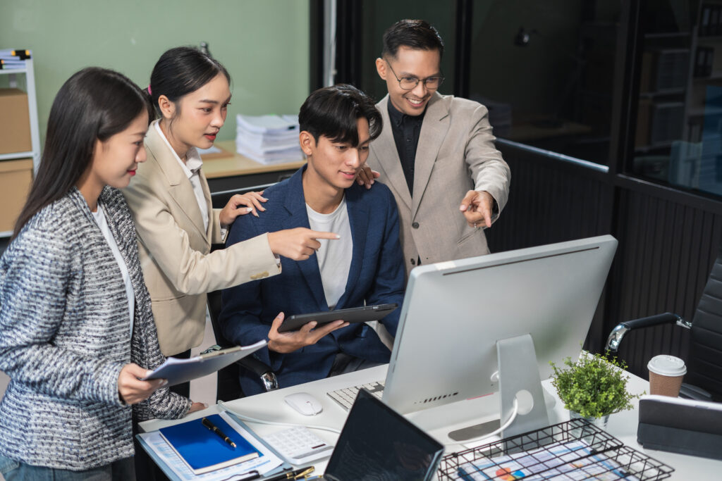financial asian advisor showing plan of investment to clients in