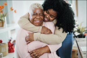 Two women hugging and smiling