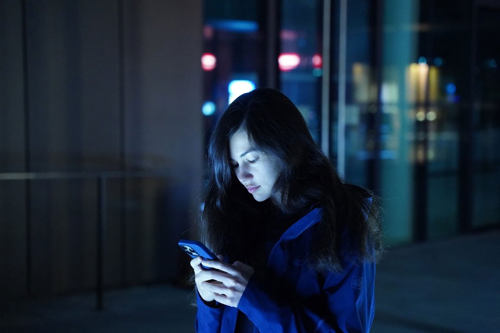 Lady on mobile phone in the dark