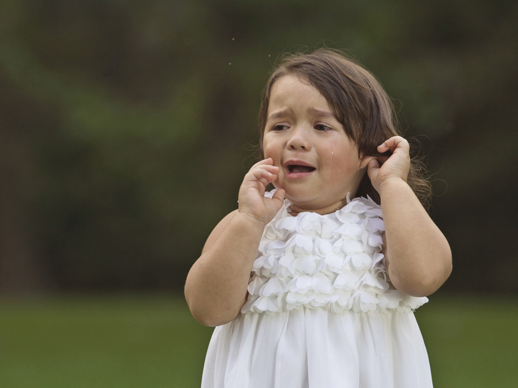 child in a dress crying