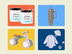 A woman in a black ruffled swimsuit with baby ointments, a gray tumbler, a toddler balance bike, and a floral baby swimsuit with a matching hat.