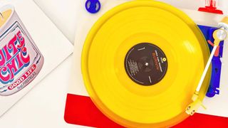 A birds eye shot of the Tinyl Play Pro record player with a yellow vinyl on the turntable