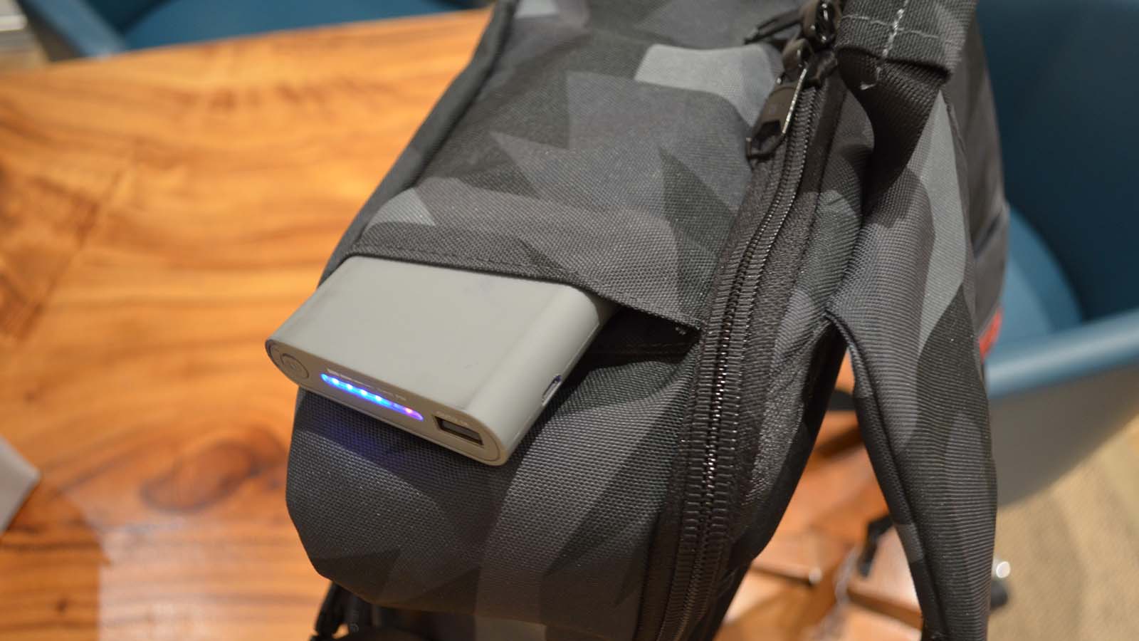 A Hex Technical Backpack on a wood grain table