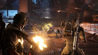 Two armored soldiers in a dimly lit, industrial sci-fi setting fire weapons at approaching alien creatures. The scene conveys intense action and urgency.