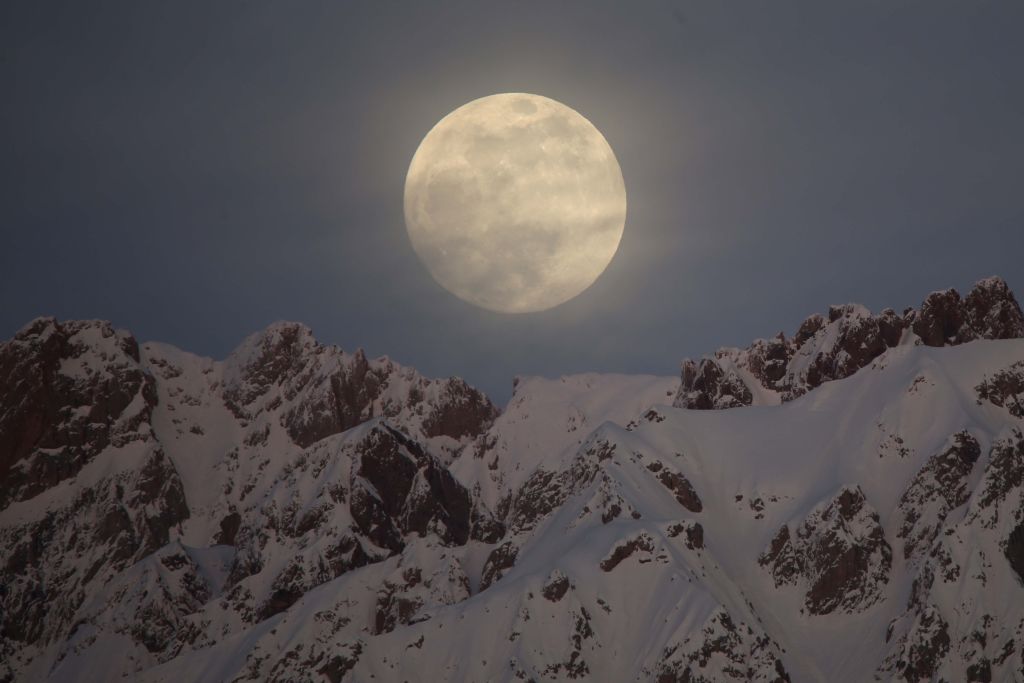 The Full Snow Moon rises behind snow-covered mountains in Hakkari province of Turkey, on Jan. 20, 2019.