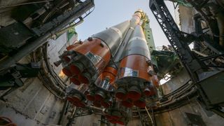 a rocket viewed from below, with five cone-shaped nozzles in the foreground