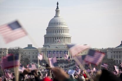 Photo of the U.S. Capitol behind of a crowd waving American flags at President Obama's inauguration on Jan. 20, 2009.