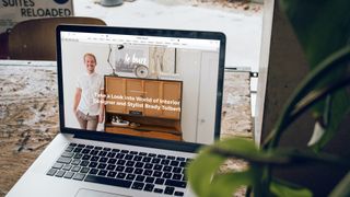 laptop open on desk displaying website