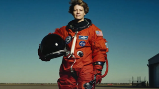 a NASa astronaut in an orange spacesuit