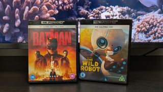 A shot of the batman and the wild robot 4K Blu-ray cases in front of a TV screen