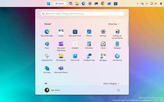 Windows 11 Start Menu with a gradient background showing pinned apps like Microsoft Edge, Photos, and Settings, creating a modern, organized feel.