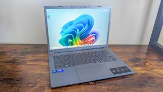 The Acer Aspire 14 AI laptop facing forward on a wooden desk.
