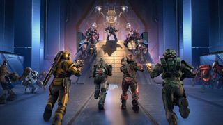 Four Spartans charge up a ramp toward a group of Banished enemies in a Forerunner arena, with a glowing structure looming above as combat unfolds on both sides.