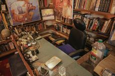 Manuj Babu Mishra’s studio, rich with full shelves, paintings, personal items and lots of colourful, lived-in decor