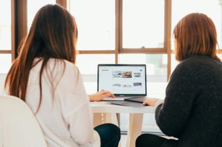 Two people at a laptop
