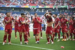 Serbia's midfielder #19 Lazar Samardzic, Serbia's midfielder #06 Nemanja Gudelj, Serbia's forward #11 Filip Kostic, Serbia's forward #14 Andrija Zivkovic, Serbia's defender #03 Nemanja Stojic, Serbia's defender #13 Milos Veljkovic, Serbia's forward #09 Aleksandar Mitrovic, Serbia's defender #25 Filip Mladenovic and Serbia's midfielder #21 Mijat Gacinovic celebrate with supporters after the UEFA Euro 2024 Group C football match between Slovenia and Serbia at the Munich Football Arena in Munich, southern Germany, on June 20, 2024.