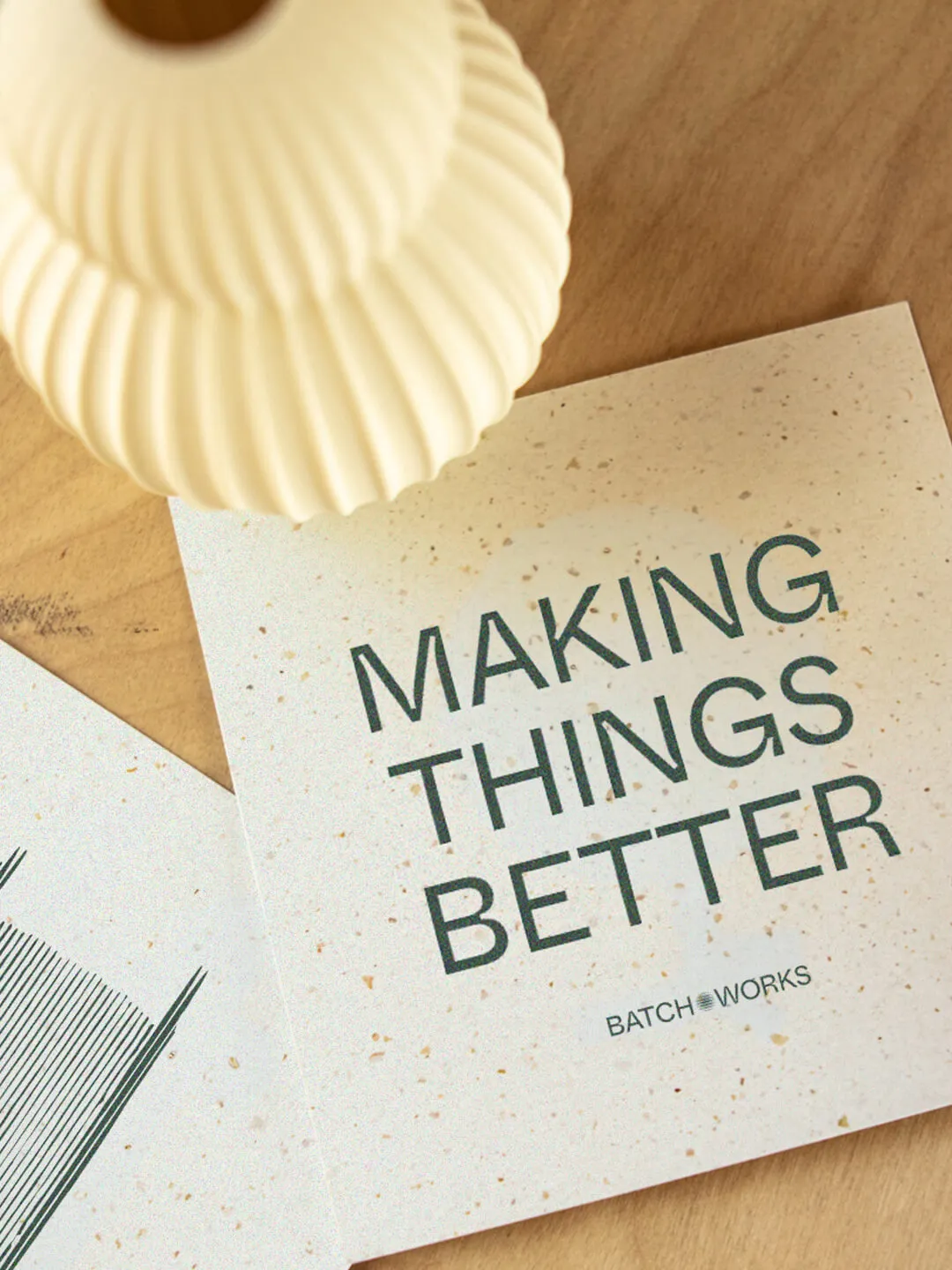 Printed promotional cards that read 'Make things. Better.'