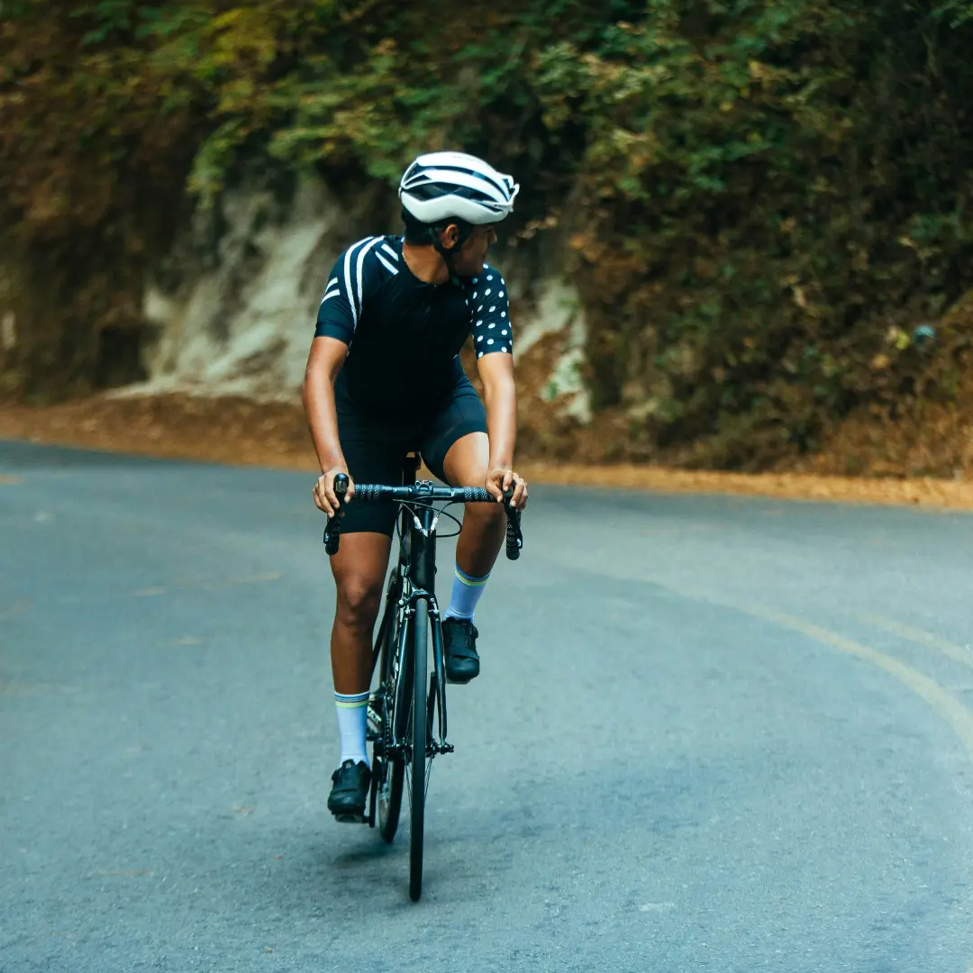 a man riding a bike down a curvy road