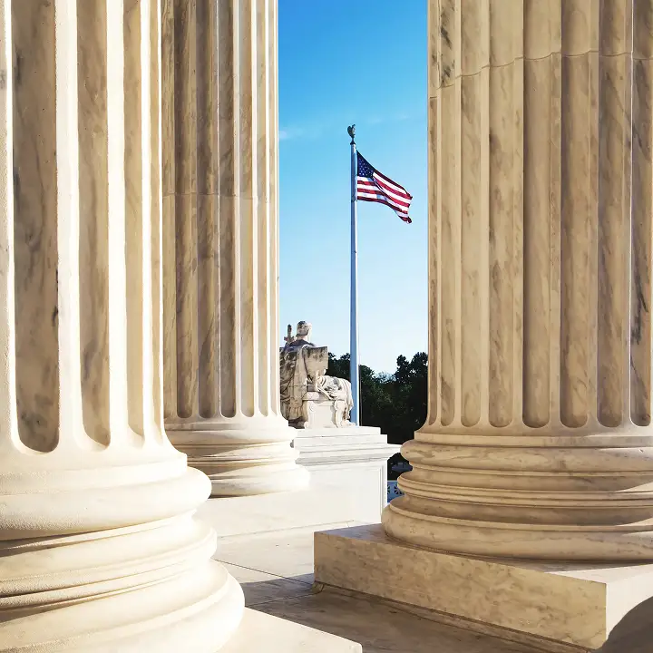 Photo of a government building and American flag.