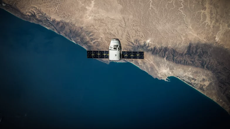 Overhead photo of a satellite orbiting earth.