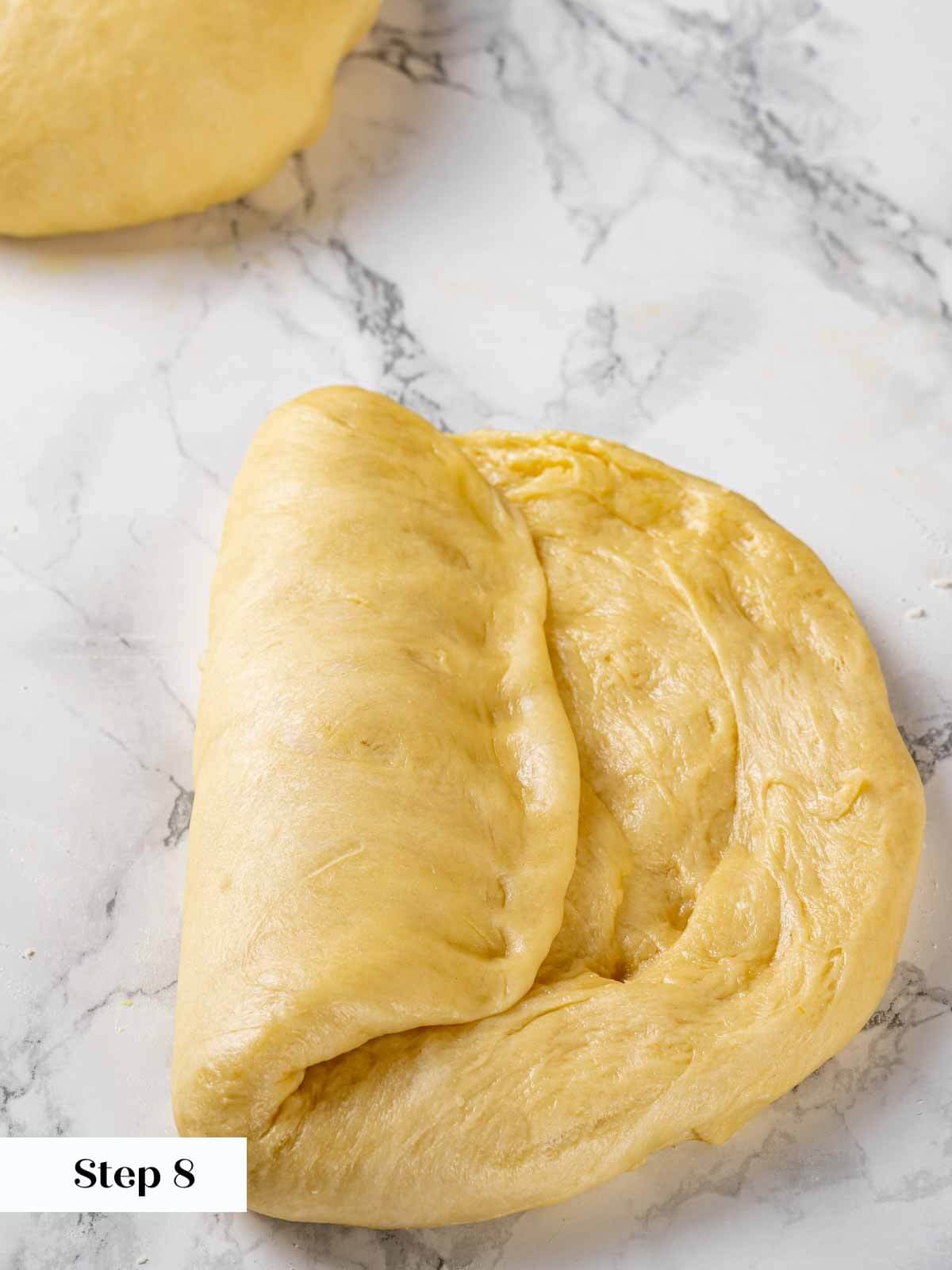 Shaping the brioche dough into a log.