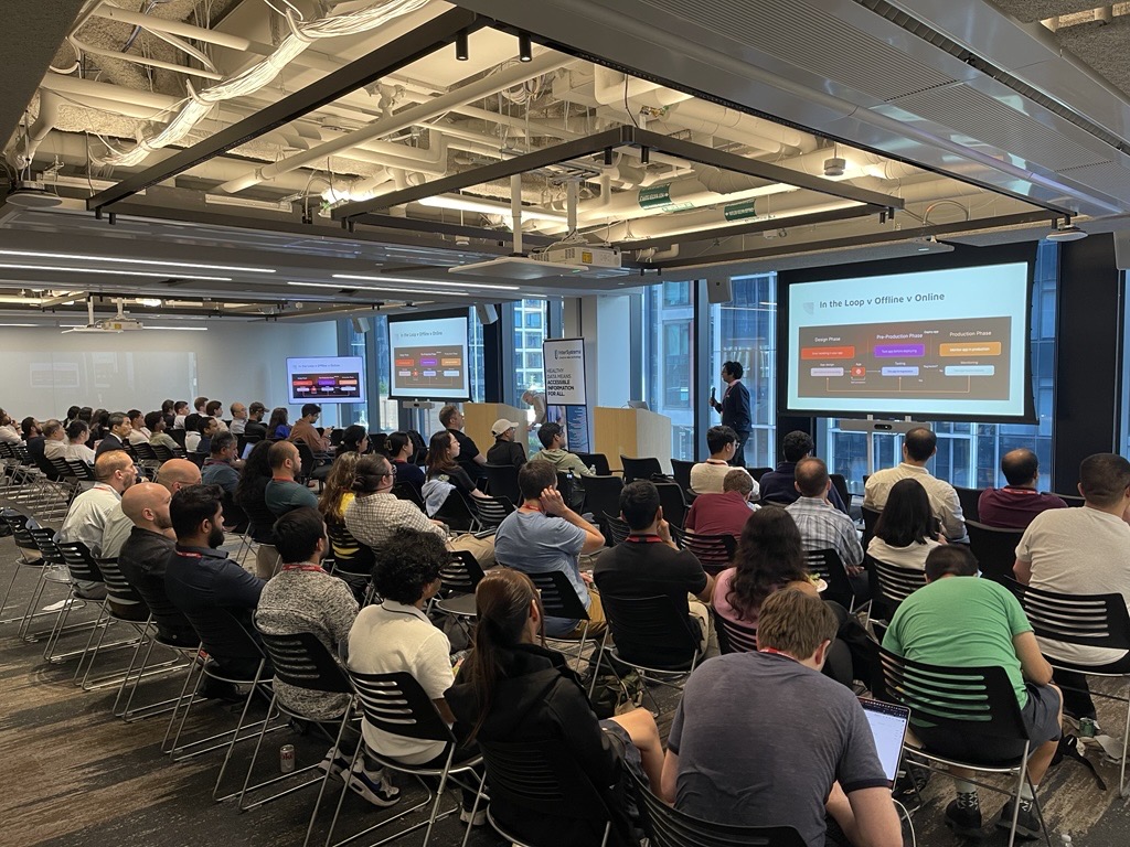 Photo of a large audience watching the speaker Jayesh Gupta present his topic