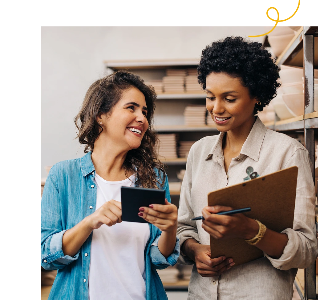 A woman wearing a blue jacket is seeing something on her teammate
