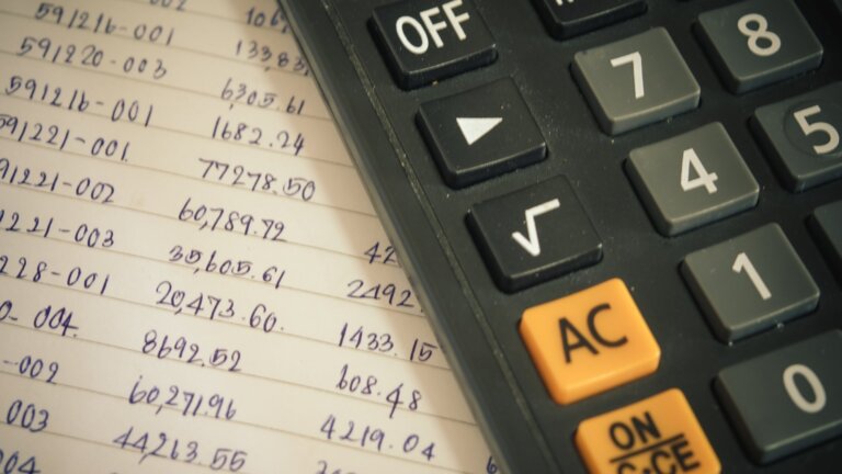 worned black calculator used for computing budget