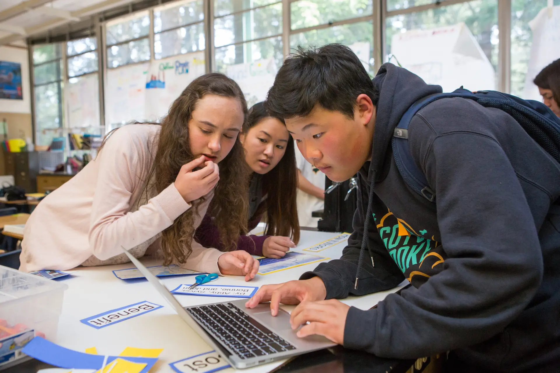 Students in a science class put the final touches on their class presentation.