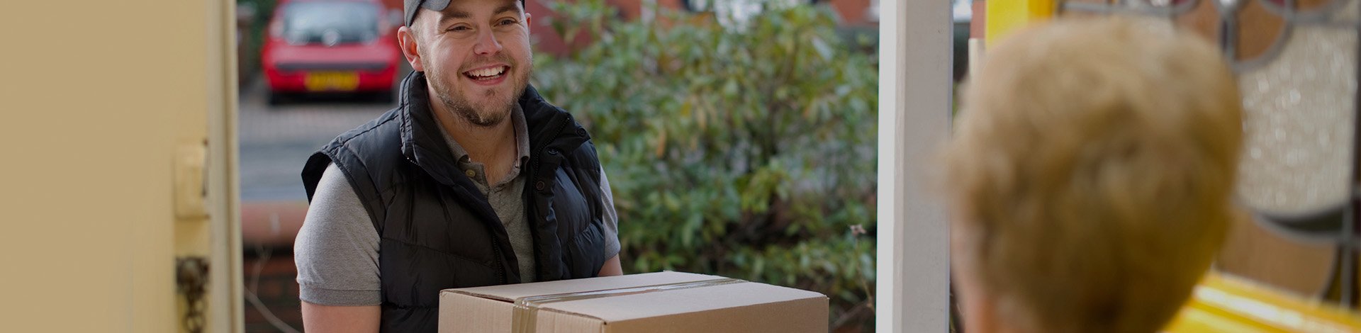 Man delivering box to house