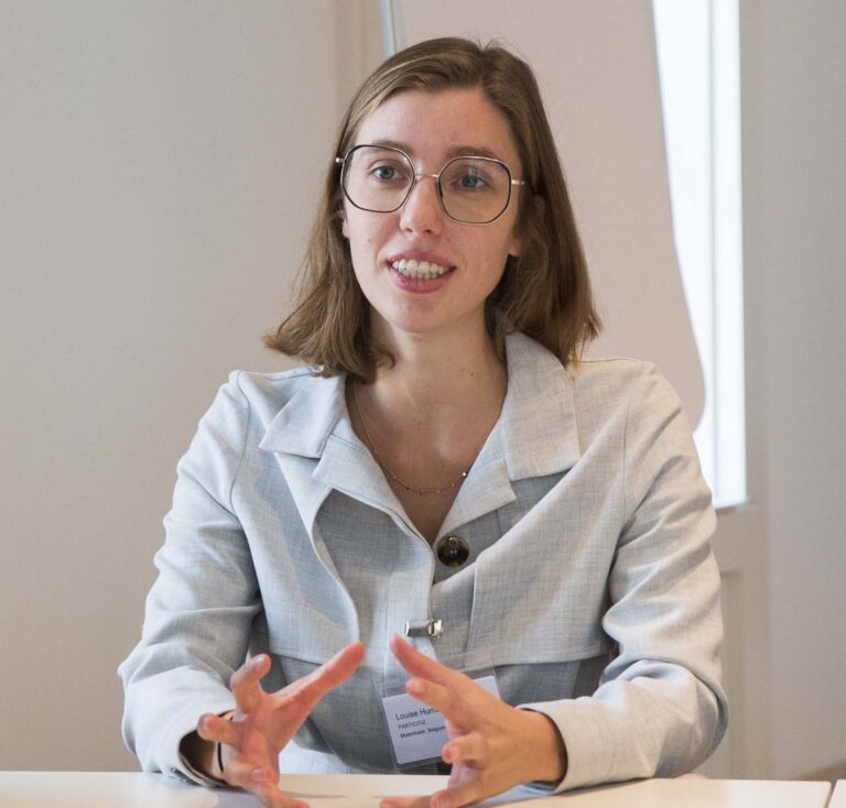 Portrait of Louise Humble speaking during a discussion on deliberative democracy and citizen participation.