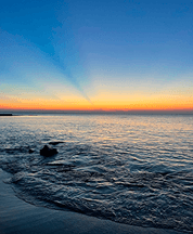 Golden sunset over the Black Sea, with soft waves meeting the horizon — a view from home in Odesa, Ukraine.