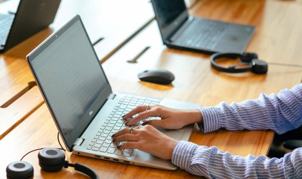 Professional working on a laptop during a cloud consulting session