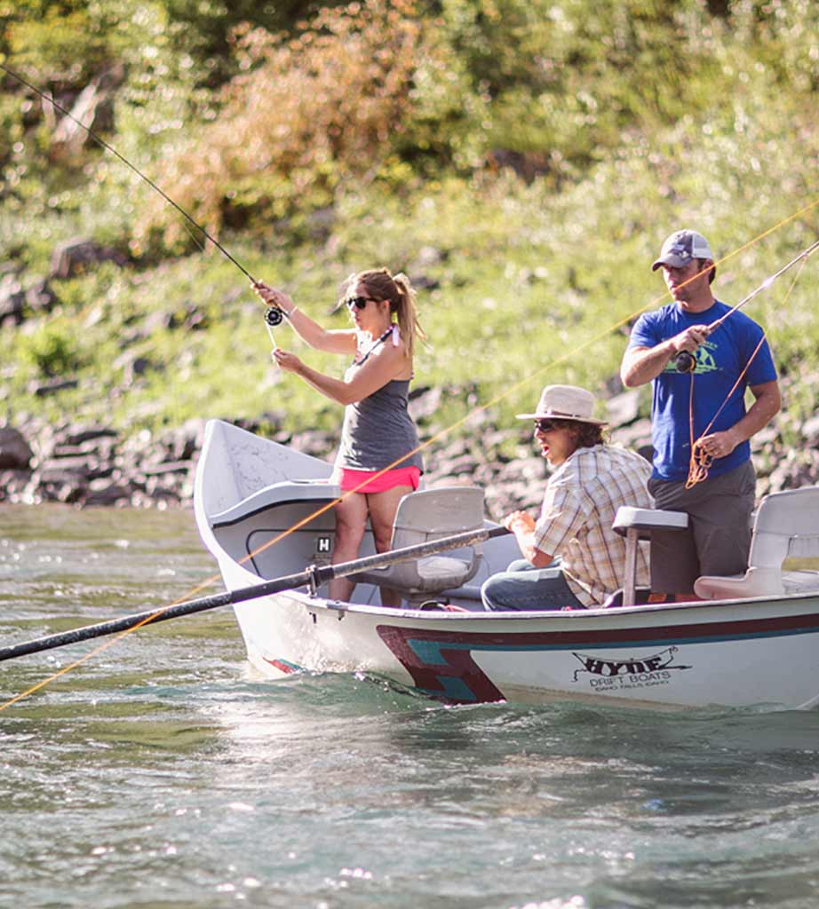 Group of three people on a boat fishing.