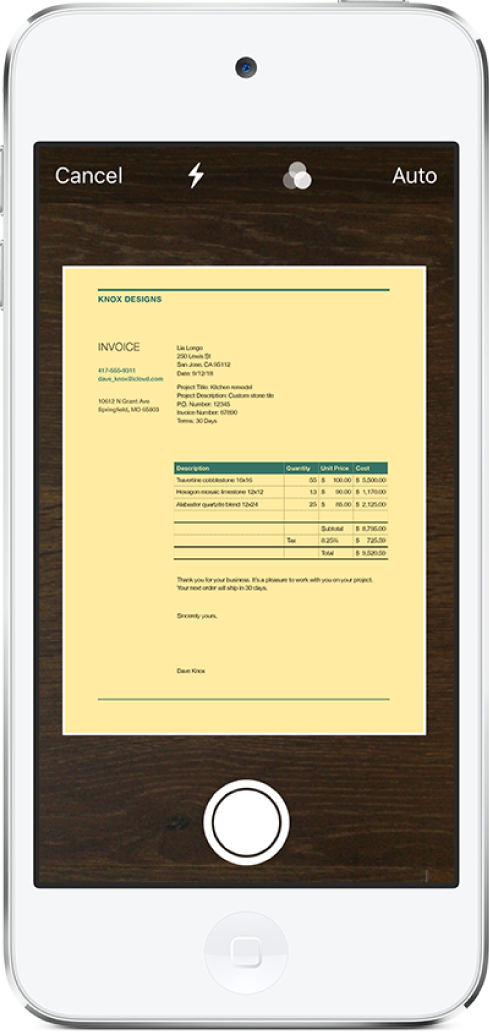 Un écran affichant un document en cours de numérisation. Le bouton de prise de photo est situé en bas au centre.