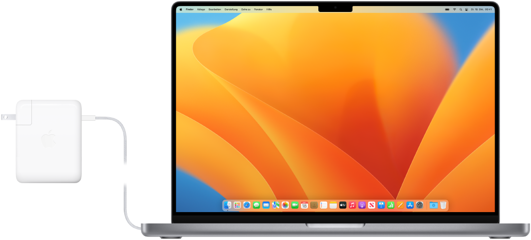 Ein 16“ MacBook Pro mit angeschlossenem Netzteil.